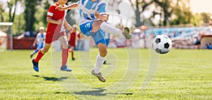 Boy Kick Soccer Ball Towards Goal and Try to Score a Goal. Kids Playing Football Ball on Grass Field