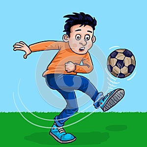 A boy kicked the football in the field