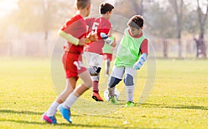 Boy kicking football on the sports field