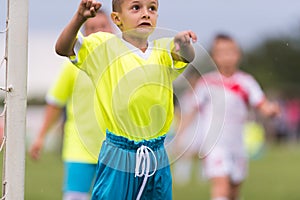 Boy kicking football on the sports field