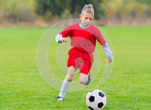 Boy kicking soccer ball