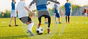 Boy kicking soccer ball. Close up action of boys soccer teams, aged 8-10, playing a football match