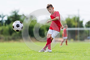 Boy kicking soccer ball