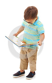 Boy kid, reading and book in studio, learning and development with thinking by white background. Child, student or