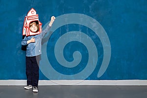 boy kid with toy spacecraft on head showing cosmic flight