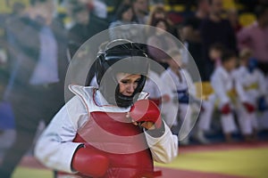 A boy in a kimono karate competition is crying because he lost the fight and was injured