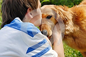 Boy kissing dog