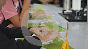 Boy in kitchen during cooking classes making dough cookie