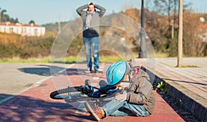 Boy with knee injury after falling off to bicycle