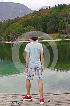 The boy is at Lake bohinj,Slovenia