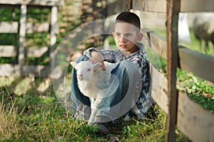 Boy with lamb on the farm