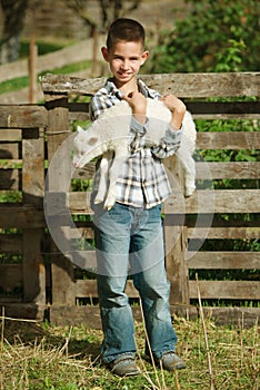 Boy with lamb on the farm
