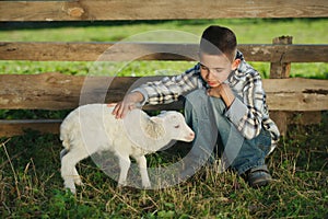 Boy with lamb on the farm