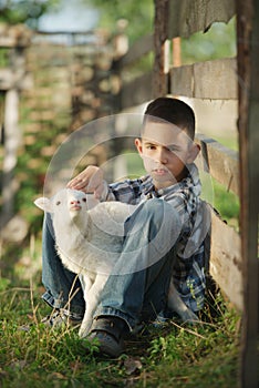 Boy with lamb on the farm