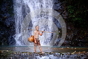 Boy laugh fishing at a waterfall countryside thailand.Fishing bo