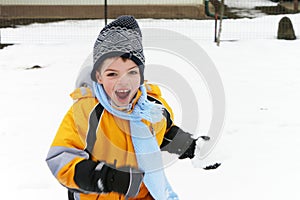 Boy laughing and having fun in a snowball fight