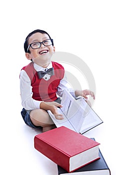 Boy laughing reading books