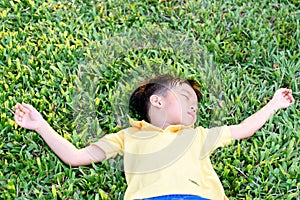 Boy lay on the green lawn