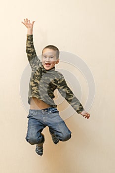 Boy laying in the house. children playing at home. jumping children. vertical photo. toned