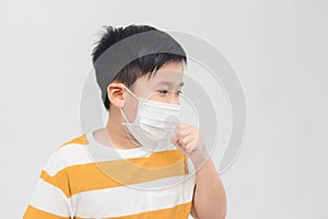 Boy leaned over and coughed in medical mask on white background