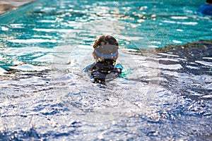 Boy learn to swim in the swimming pool