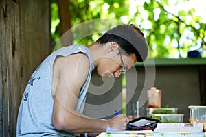 The boy learning outdoors wrighting