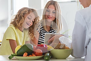 Boy learning the secrets of healthy nutrition during classes with a dietitian