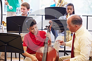 Boy Learning To Play Cello In High School Orchestra