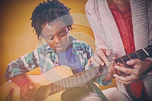 Boy learning to play guitar