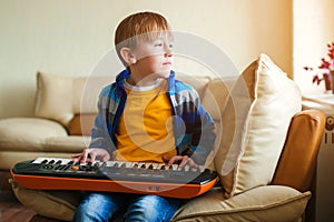 Boy learning to play musical instruments at home