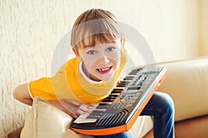 Boy learning to play the synthesizer. Music education and extra-curricular lessons photo