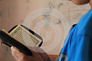 Boy Learning to Read Quran in Arabic