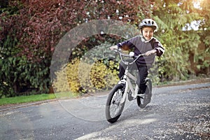 Boy learning to ride his bike