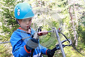 Boy learning to use carabiner