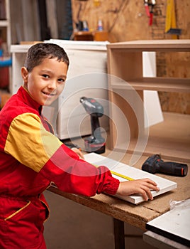 Boy learning wood carving. young carpenter working in a workshop