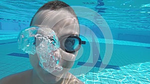 boy learns to dive in swimming glasses in the pool of a sports club.