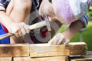 Boy learns to hammer nails