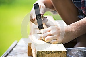 Boy learns to hammer nails