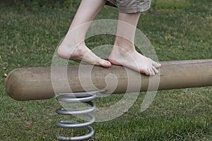 Boy legs on a balance beam. Go ahead. Success steps.