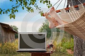 Boy legs on hammock at nature background. Relax in the hammock in the summer garden. Concept rest and relaxation after distant