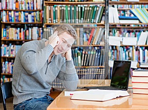 Boy in library talking on the phone