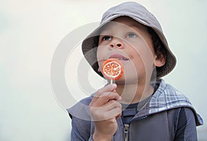 Boy licking a sweet lollipop stock photo