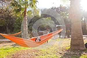 The boy lies in a hammock