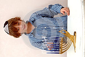 Boy lighting Menorah