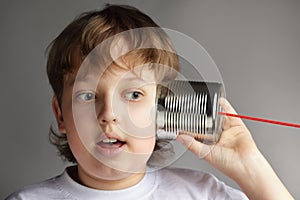Boy listen tin can telephone