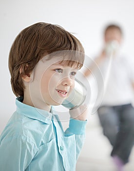 Boy listen tin can telephone