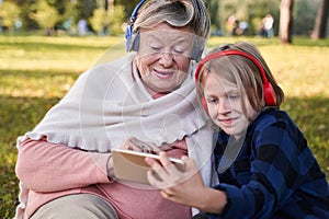 Boy listening music with his granny