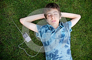 Boy listening to music on grass