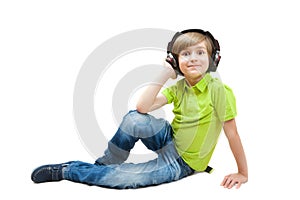 The boy listens music, isolated on white