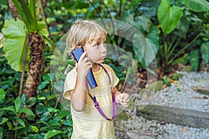 Boy listens to a radio guide, tourism concept